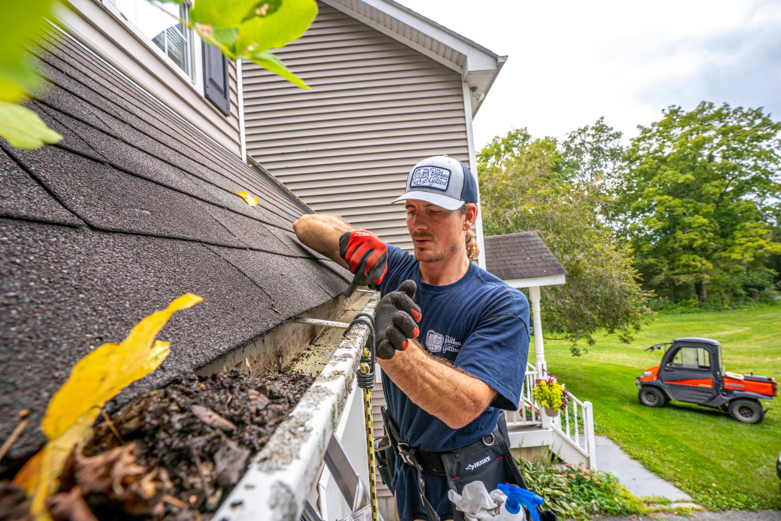 Technician provides gutter cleaning services