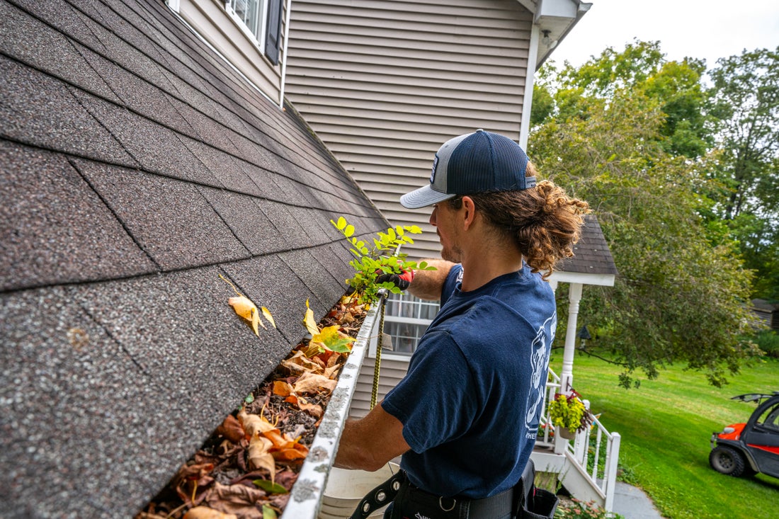 Technician provides gutter cleaning services