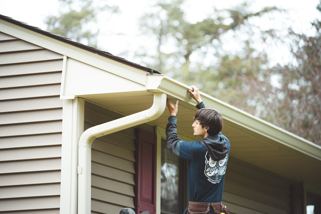 Technician provides gutter repair services